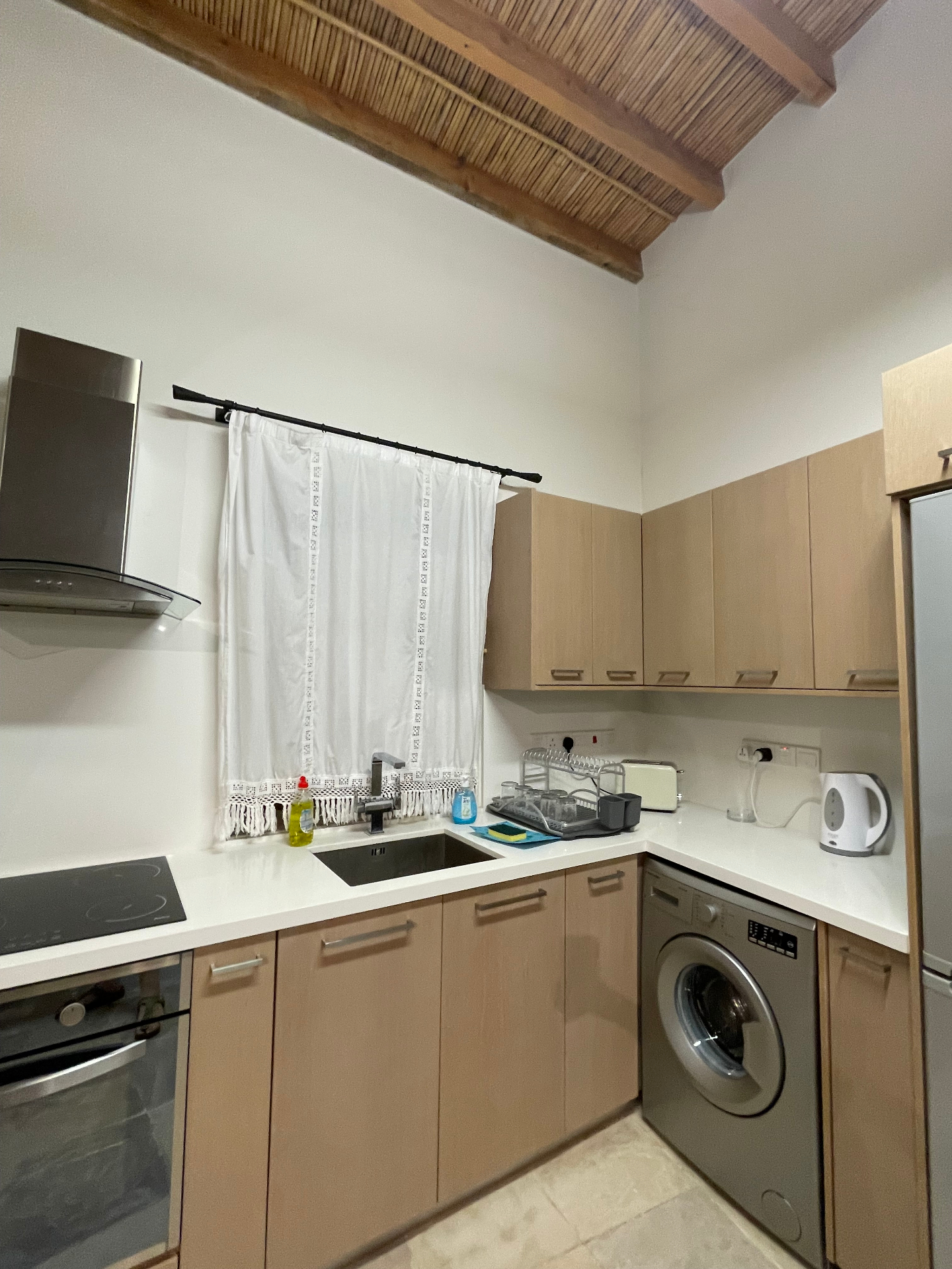 The fully equipped kitchen with washing machine