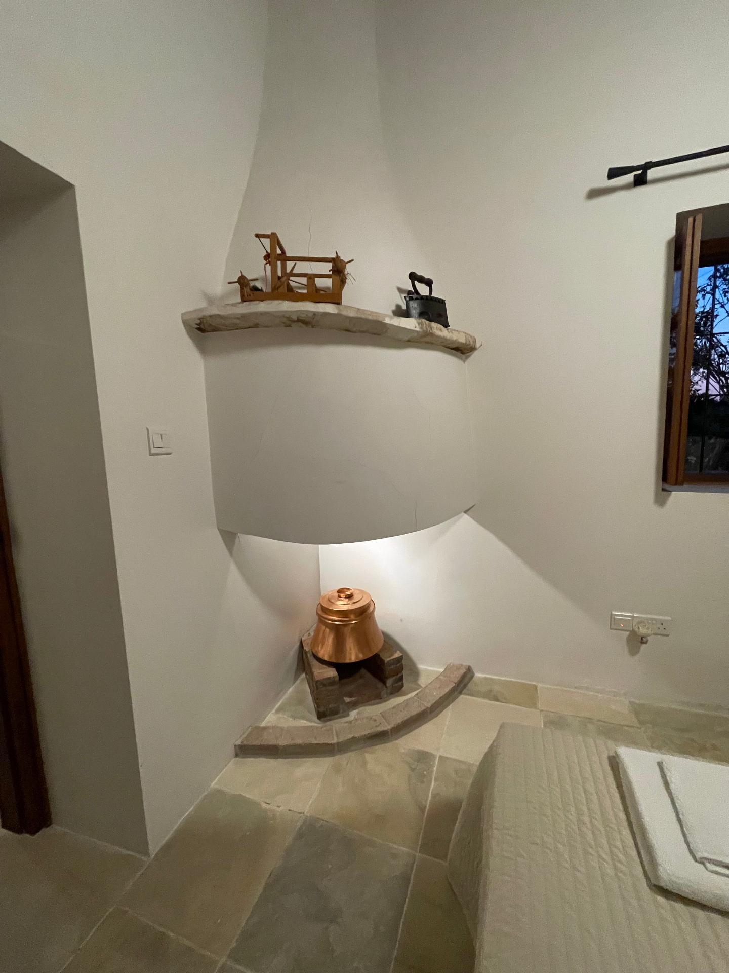 Restored fireplace nook with traditional artefacts