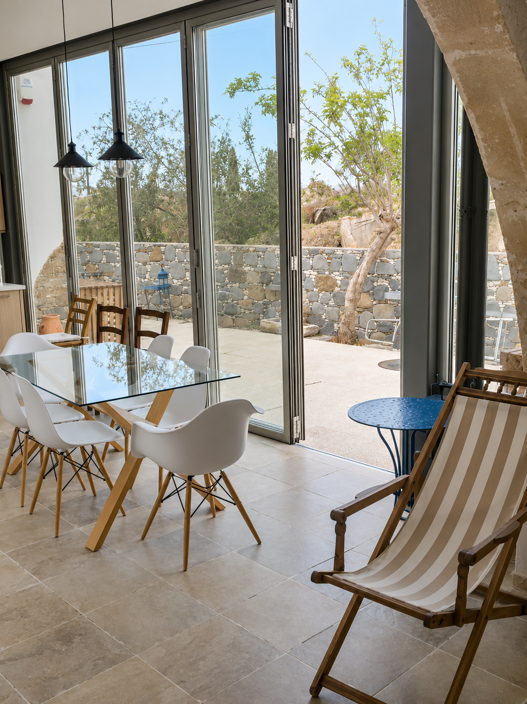 The dining area opening onto the courtyard through glass doors
