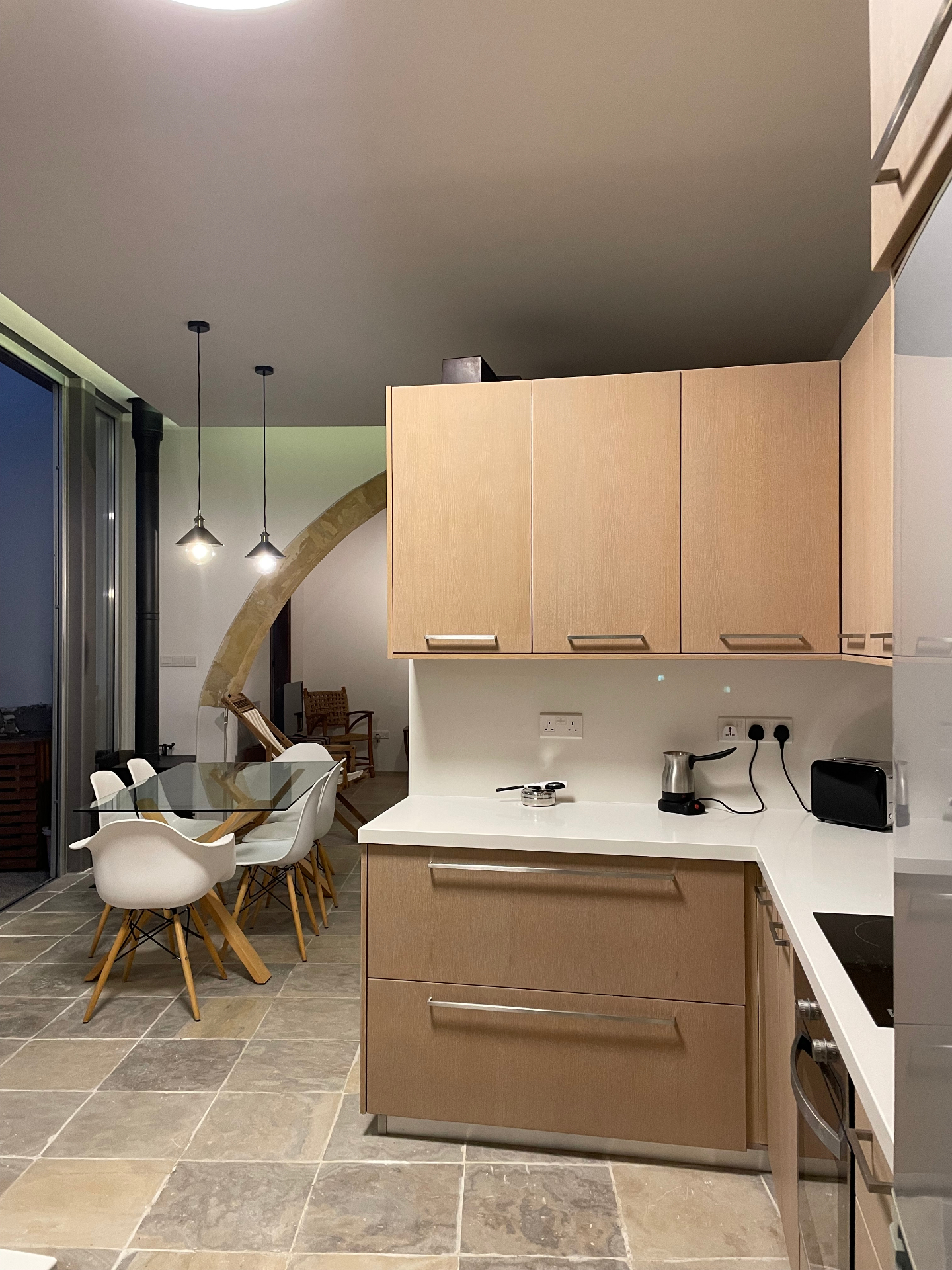 The open-plan kitchen and dining area at dusk
